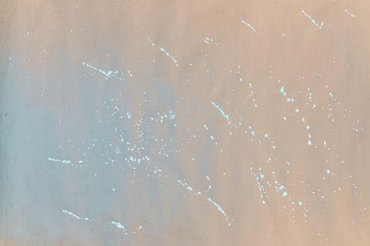 Texture of gift wrapping paper. Abstract drawing on craft paper for surprises. White splashes and paint splatters.