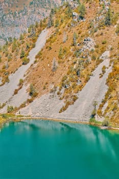 Lake in the mountains. Rocky lake shore in the mountains. Happy international mountain day.