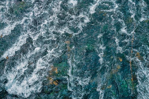 Mountain fast-flowing river with waves. Water Texture