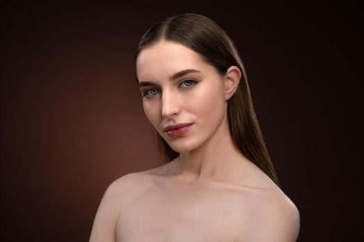 Standing half-turned natural beauty woman with no make up face portrait. Healthy pure skin model posing on camera isolated on black background. Natural make up concept. Spa and beautiful concept.