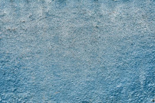 Blue block cracks textured wall background.