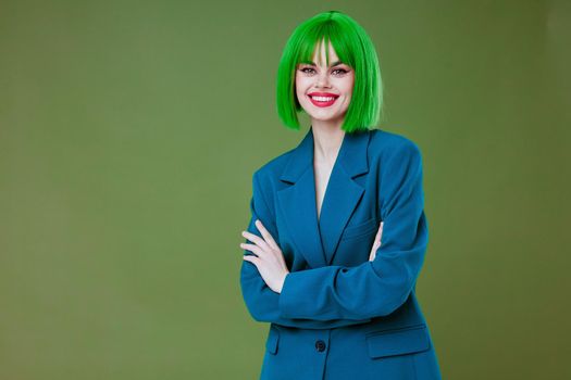 Portrait of a charming lady fun gesture hands green hair fashion color background unaltered. High quality photo