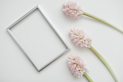 mockup with pink flowers and blank photo frame with copy space