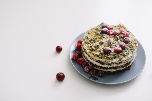  cake with spinach and cream decorated with fresh cranberries, healthy nutrition, diet breakfast