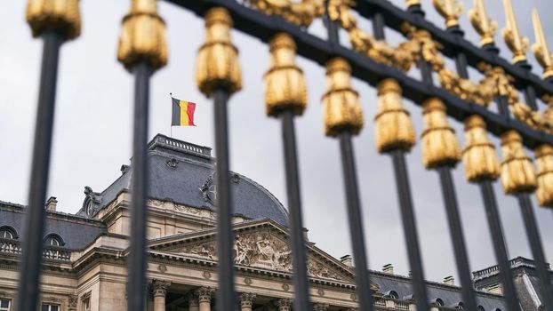 The Royal Palace in Brussels, Belgium. View through the metal fence with golden details