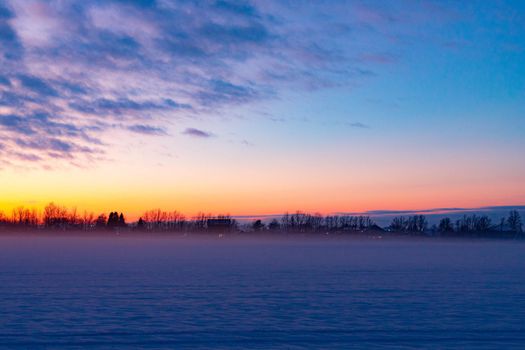 Winter sunset in the field . Winter landscape. Nature.