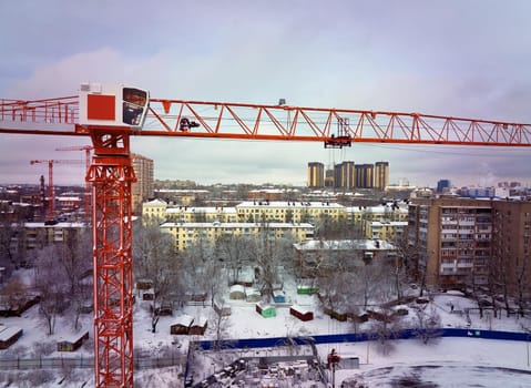 Construction Crane from Above. tower crane on the construction site aerial view. Aerial View Of construction site with crane. Construction workers are building. Top view.