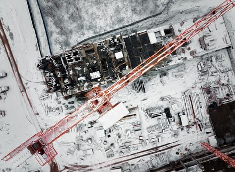 Construction Crane from Above. tower crane on the construction site aerial view. Aerial View Of construction site with crane. Construction workers are building. Top view.