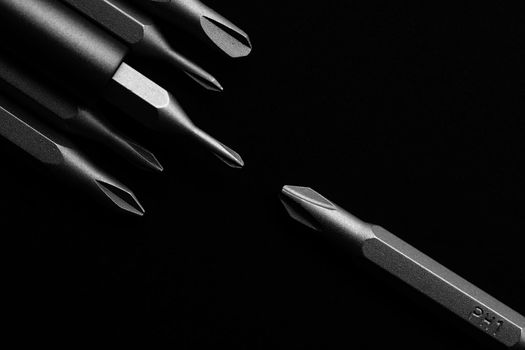 Screwdriver tips different shapes and sizes close up. Manual metal mini screwdriver and set of the interchangeable bits. Precision Screwdriver Kit. Steel Precision Magnetic Bits.