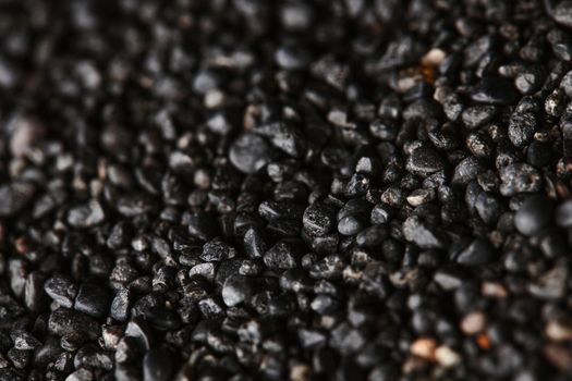 Texture of black volcanic sand for background. Black Sand beach macro photography. Close-up view of volcanic sand surface. Icelandic Black Sand macro photography. Black pebble background.