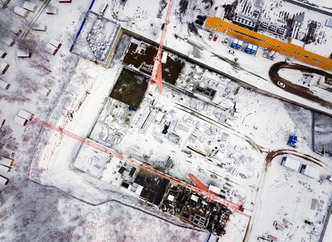 Construction Crane from Above. tower crane on the construction site aerial view. Aerial View Of construction site with crane. Construction workers are building. Top view.