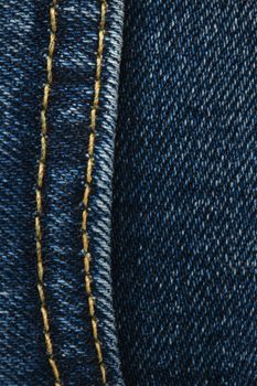 Seams on jeans close-up. Stitching on denim. Close up of blue jeans background. Denim texture.