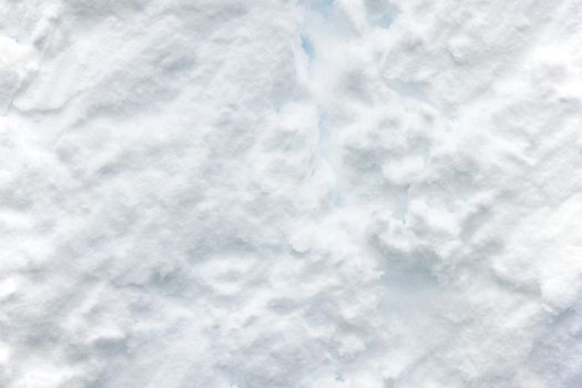 Wall of snow. Snowdrift surface, Winter background. The texture of snow removed with a bucket. Removed compressed snow.
