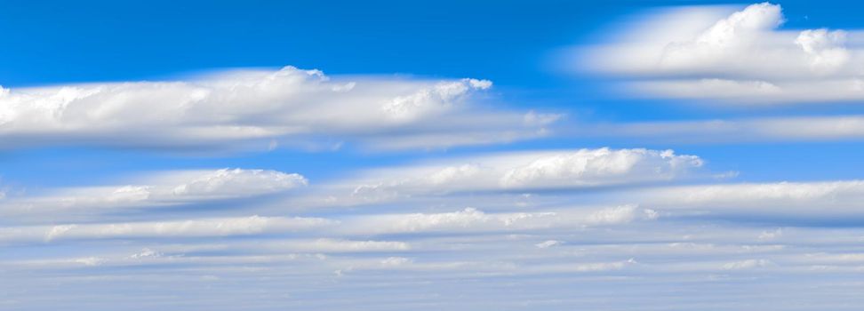 Beautiful panorama of the sky. Panorama of the sky in the clouds. Clouds float across the blue sky, long exposure frame.