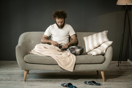 Lonely Guy Looks at his Penis Before Going Asleep. Man Looks to his Pants. Close-up. High quality photo