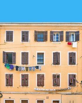 Picturesque typical Italian or Croatian slum residential house under a blue summer sky with a single cloud