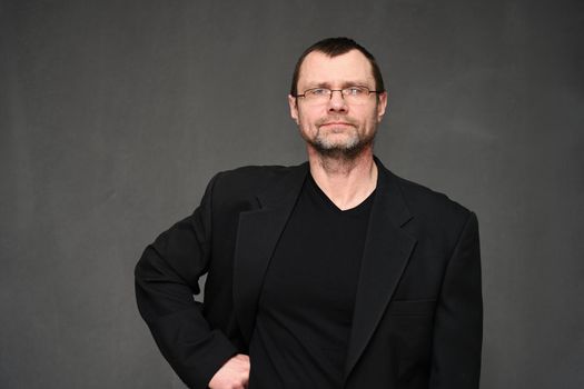 Portrait of a business man with a smile on a black background