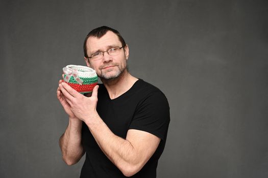 side view portrait of a cute man with glasses holding a basket in his hand