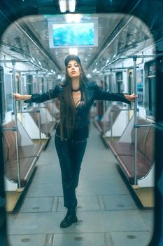 Stylish Beautiful Woman Standing inside Empty Subway Car. Sexy Caucasian Woman of 20s in Empty Underground Train. Full-length. High quality photo