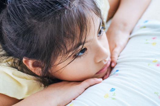 Adorable girl thinking in bed, or she could be sad too