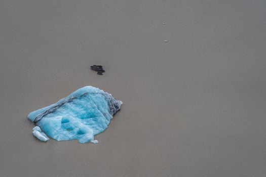 Iceberg floating over the brown glacier lake