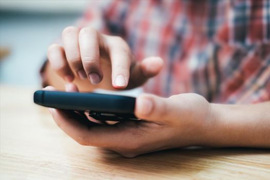 Young man using mobile phone. Using online connect technology for business, education and communication.