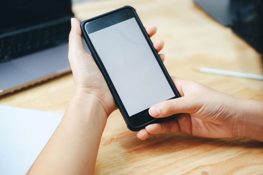 Close up of man hand holding smart phone. Blank screen mockup for graphics display montage.