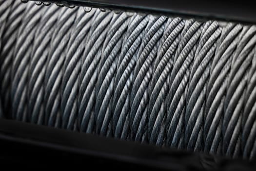 Metal cable winch. Steel rope winch close-up. Strong still background.