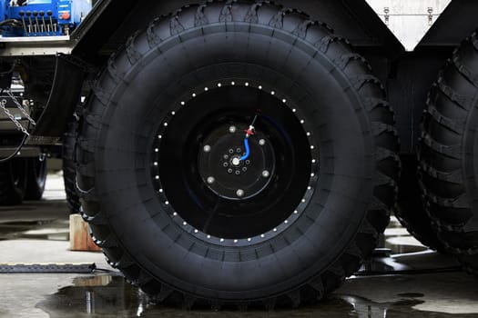 Low pressure tires, with automatic tire pumping system. Extreme patency. Giant Wheels of an all-terrain vehicle. ATV monster car.