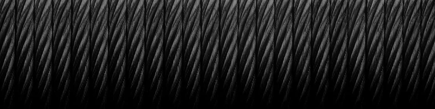 Metal cable. Metal cable winch. Black Steel rope winch close-up. Strong still Black background.