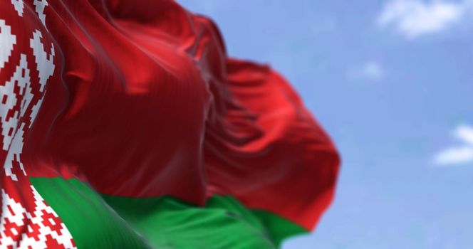 Detail of the national flag of Belarus waving in the wind on a clear day. Belarus is a landlocked country in Eastern Europe. Selective focus.