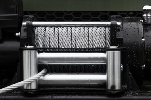 Powerful winch with steel rope. Metal cable winch. Steel rope winch close-up.