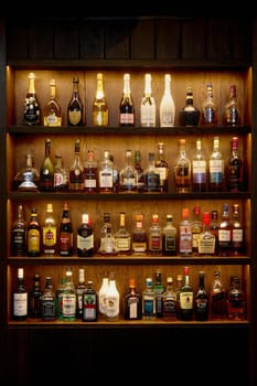 Bottles With Alcoholic in a bar. Bottles of alcoholic beverages are on the shelves. Bar on the wall. 06.06.2021, Rostov region, Russia.