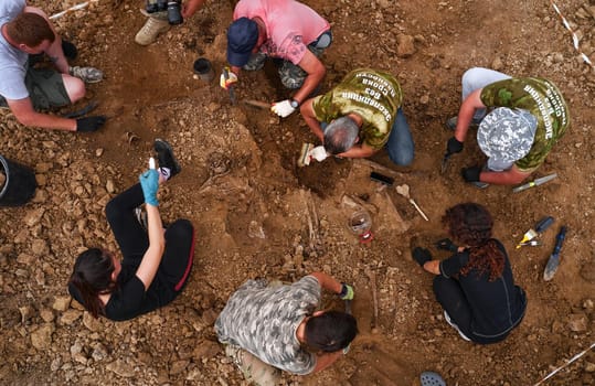 Excavations at the site of a war crime. Site of a mass shooting of people. Human remains (bones of skeleton, skulls). Human remains of victims of the Nazis. 28.08.2021, Rostov region, Russia.