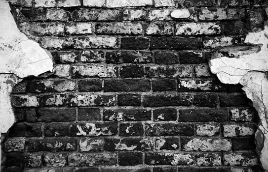 Old Brick Wall with plaster remnants, Brick wall background texture.