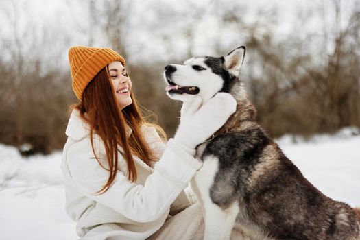 Happy young woman winter outdoors with a dog fun nature winter holidays. High quality photo