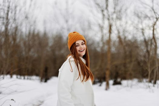 cheerful woman in winter clothes in a hat fun winter landscape winter holidays. High quality photo