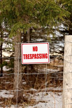 No Trespassing Sign Posted on a Wire Fence in a Rural Setting. High quality photo