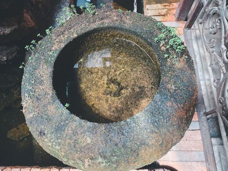 Big earthen jar, Water bowl or jar made from clay covered with moss naturally occurring in a moist and shady atmosphere put decorations in the garden