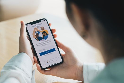 CHIANG MAI, THAILAND - JULY 26, 2020 : A working from home employee is downloading the Microsoft Teams social platform, ready for remote working in isolation from home.