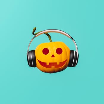 halloween pumpkin with happy face and headphones on blue background. musical avatar. 3d rendering