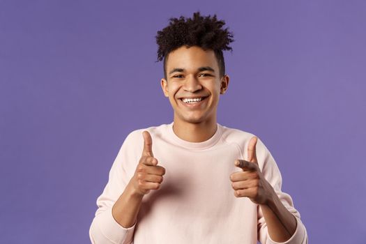 You got it. Close-up portrait of smiling cute young hispanic man saying good luck, pointing fingers at camera with pleased cute grin, encourage person apply for job, headhunter picking new candidates.