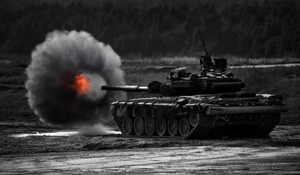 Shot from a tank gun with a smoke ring, the frame of military operations. Russian Modern tank Shooting at a target. Smoke, explosion, military Exercises, Military operations.