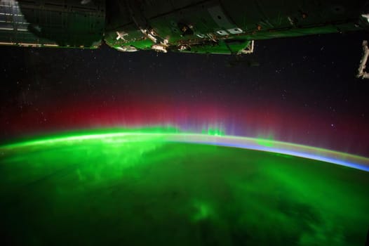 A view of the night earth taken aboard the International Space Station showing an aurora. Disturbances in the magnetosphere caused by solar wind. Element of this image furnished by NASA.