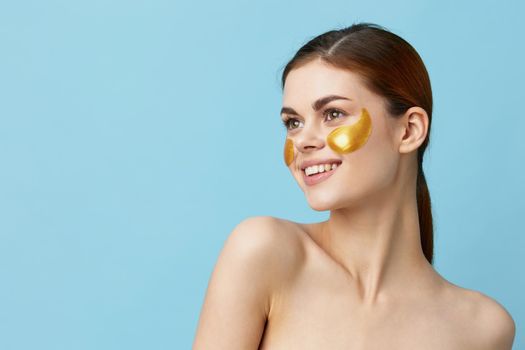 pretty woman skin care face patches bare shoulders hygiene isolated background. High quality photo