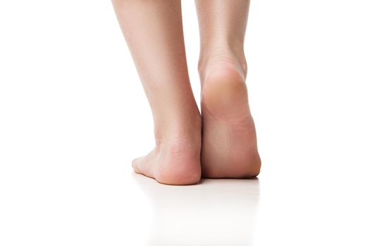 Woman foot on white background, isolated, close-up. Back view