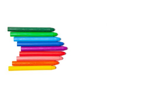 Crayons lined up in rainbow isolated on white background.