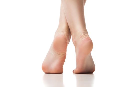 Woman foot on white background, isolated, close-up. Back view