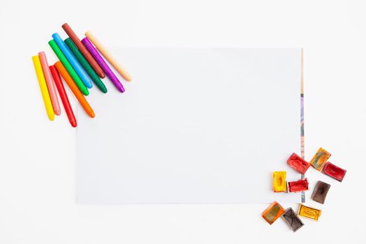 Colour pencils and watercolor on paper blank isolated on white background close up