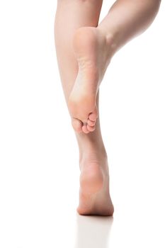 Woman foot on white background, isolated, close-up. Back view